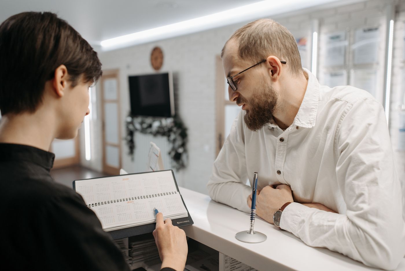 Reception — patient being greeted at the front desk